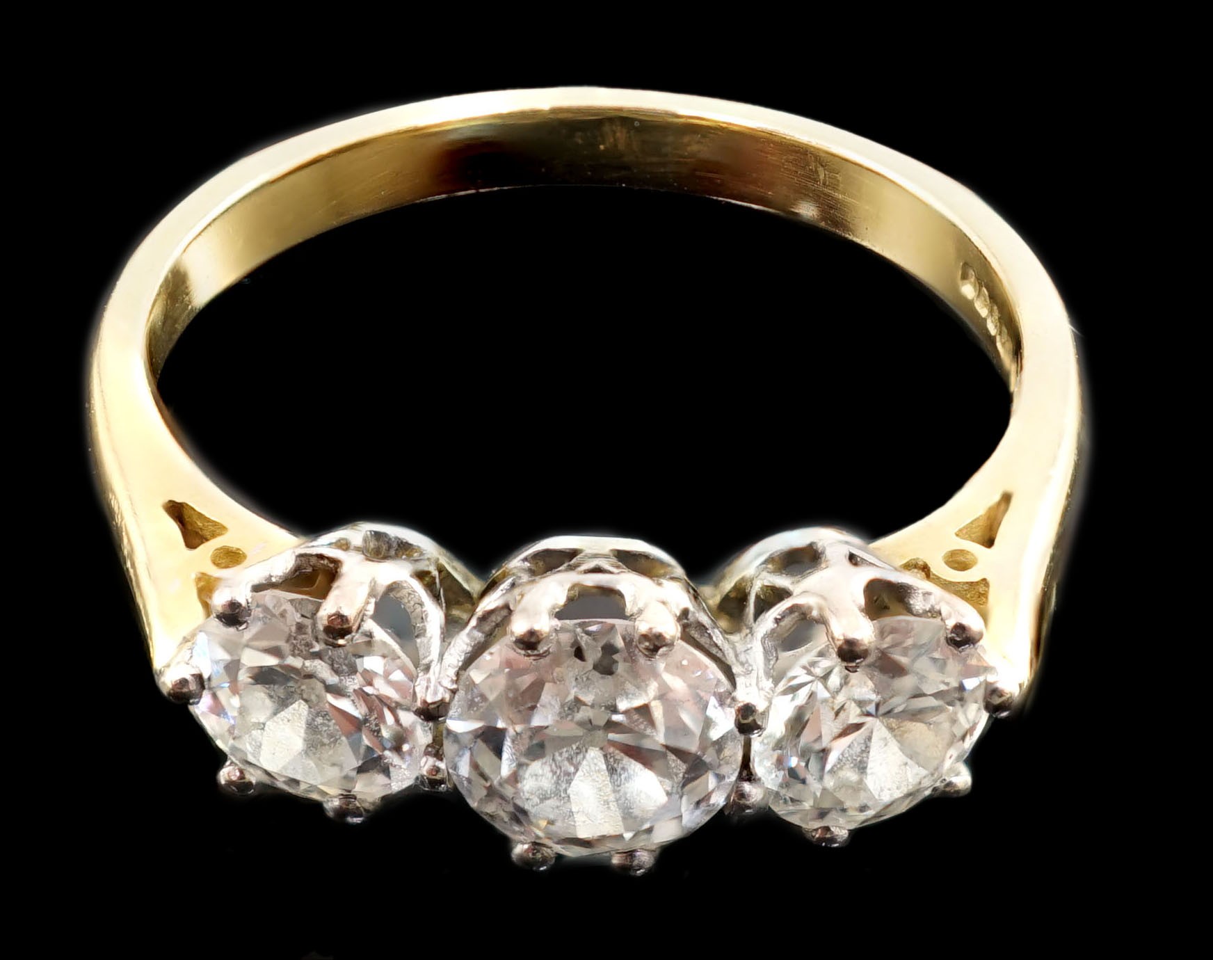 A modern 18ct gold and three stone diamond set ring